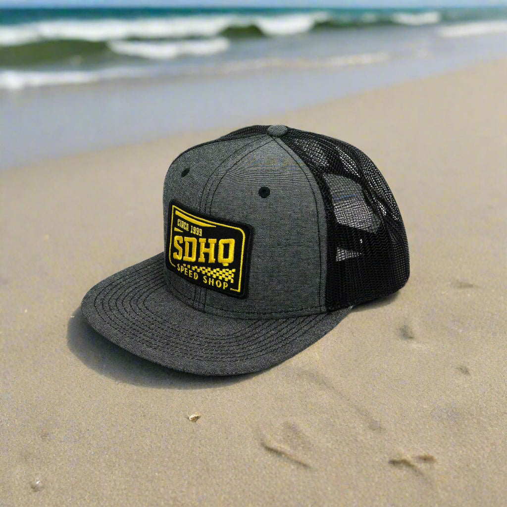 SDHQ Speed Shop Trucker Hat flat bill on beach display