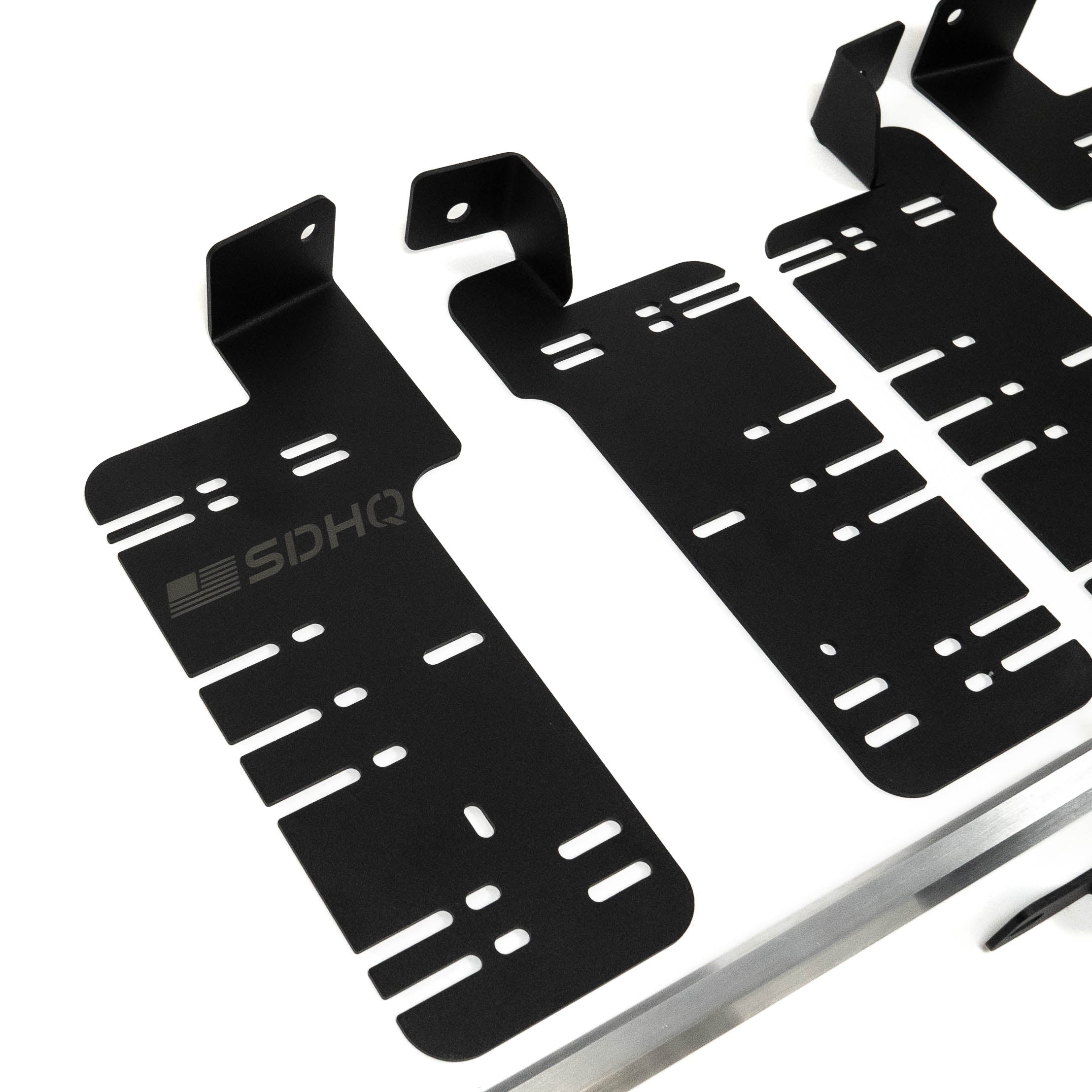 SDHQ Built '21-24 F150 / Raptor Behind the Grille Light Mounting Kit Close-up Display of Included Parts and Hardware 